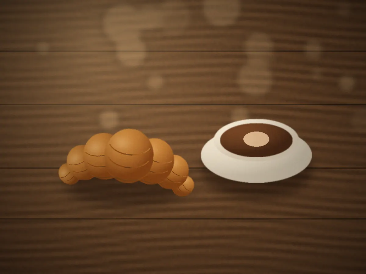 Croissant and coffee on a table, ready for a conversation
