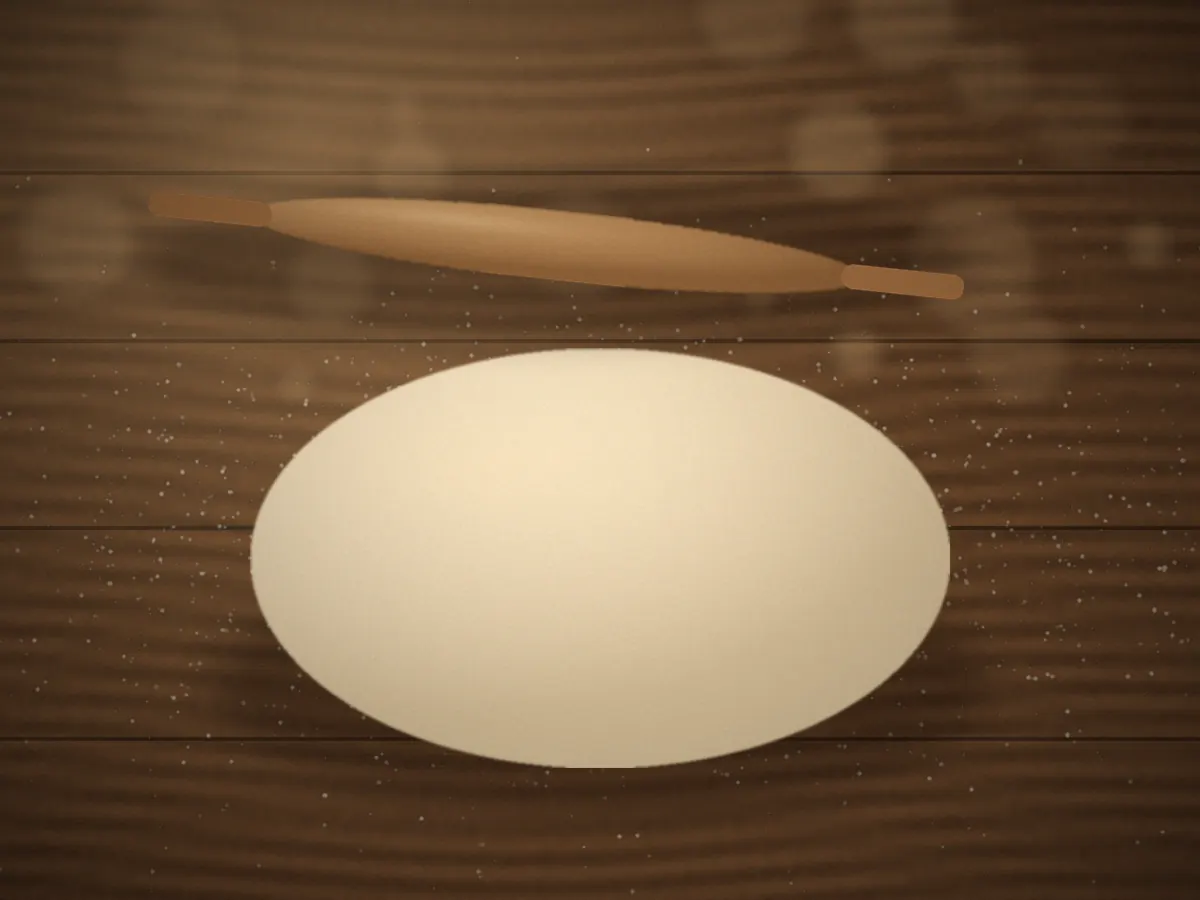 Wooden rolling pin resting on a sheet of pastry dough dusted with flour